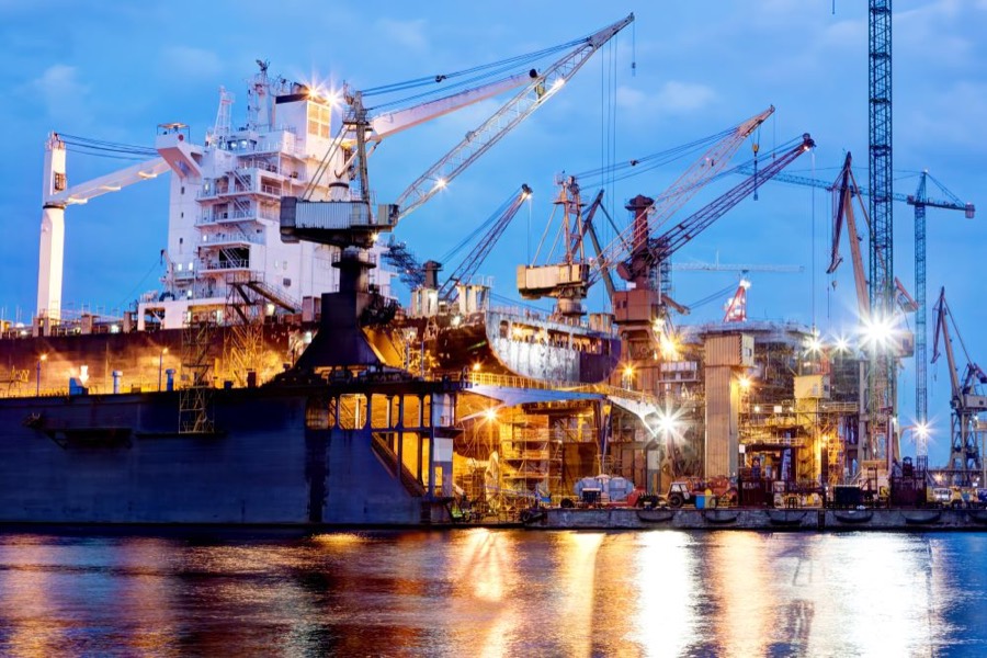 Industrial plant and shipyard illuminated at night