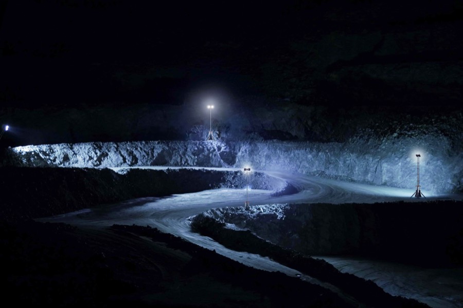 Litenza light towers illuminating an open-pit mining haul road at night